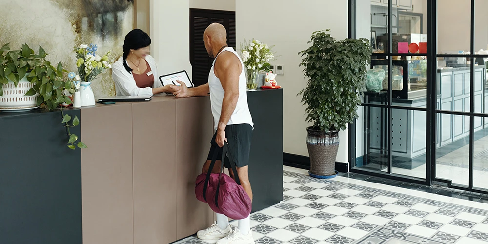 a man consulting sport facility at reception