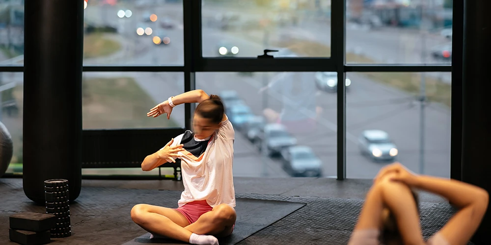 a women is strecting in a fitness room